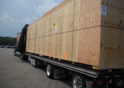 Large custom export crate manufactured by Fox Valley Wood Products on flat bed truck.