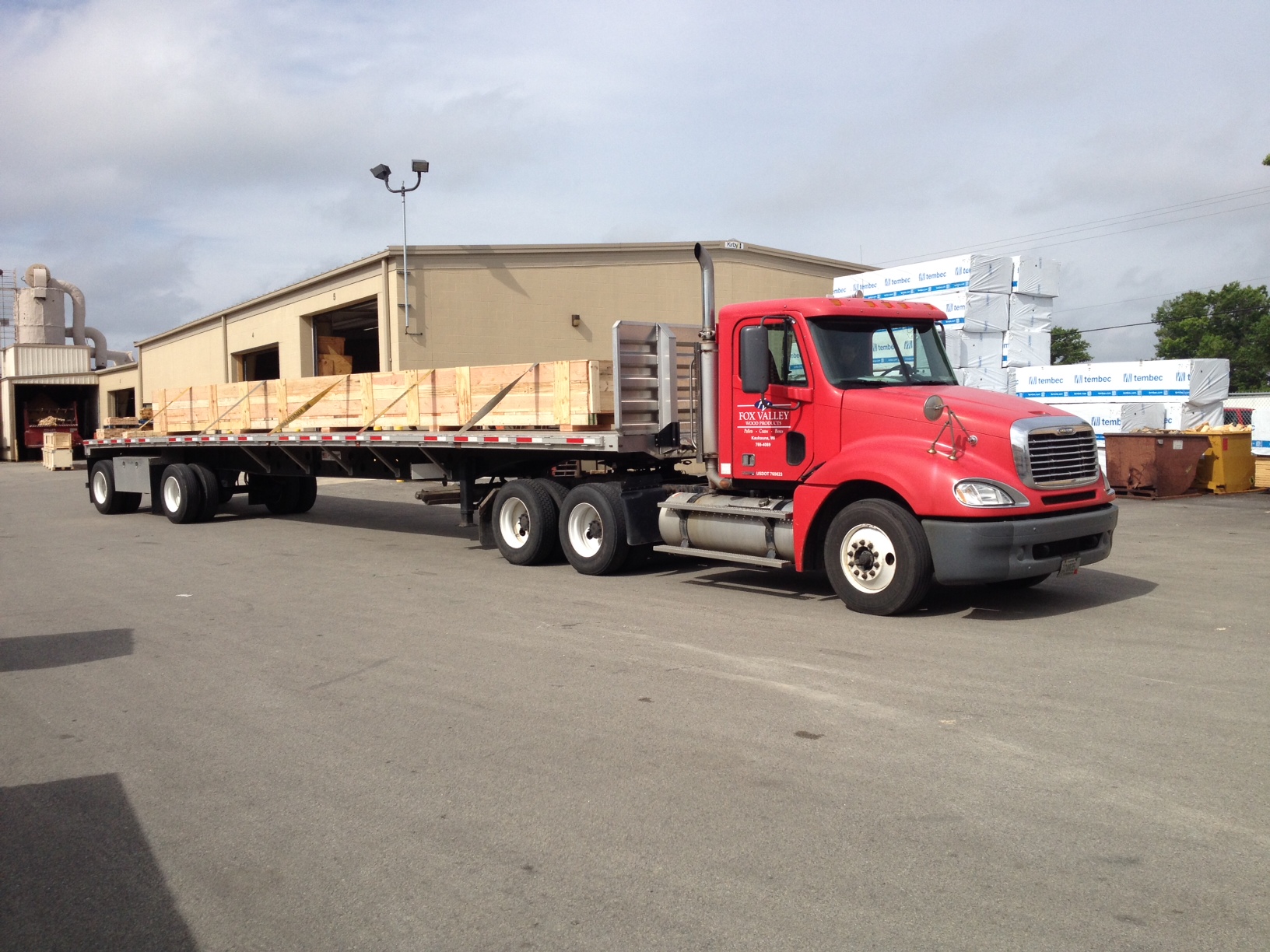 Truck towing a large roll crate